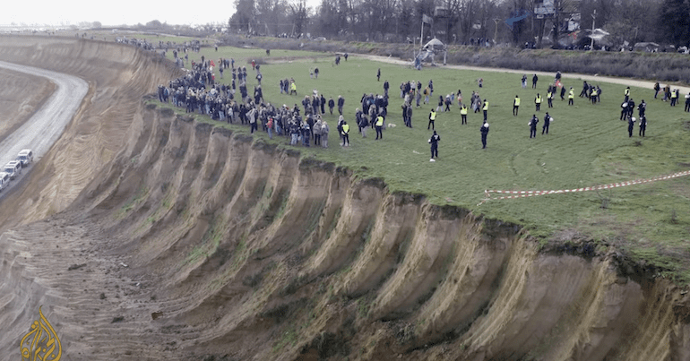 Protestors line the edge of part of the vast Garzweiler mine in Germany