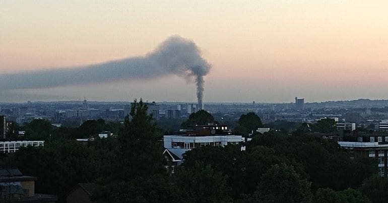 Grenfell Tower burning at sunrise