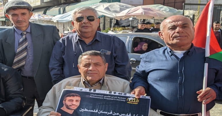 Palestinian demonstrators in Tulkarem carrying a photo of Nasser Abu Hmeid