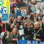NHS workers on a protest and Rishi Sunak looking on in horror