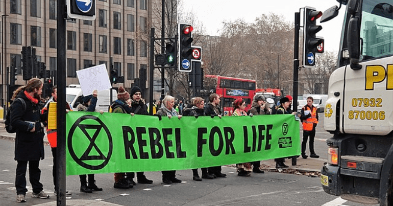 Extinction Rebellion, 'swarming roadblocks' (with banner 'Rebel for life').