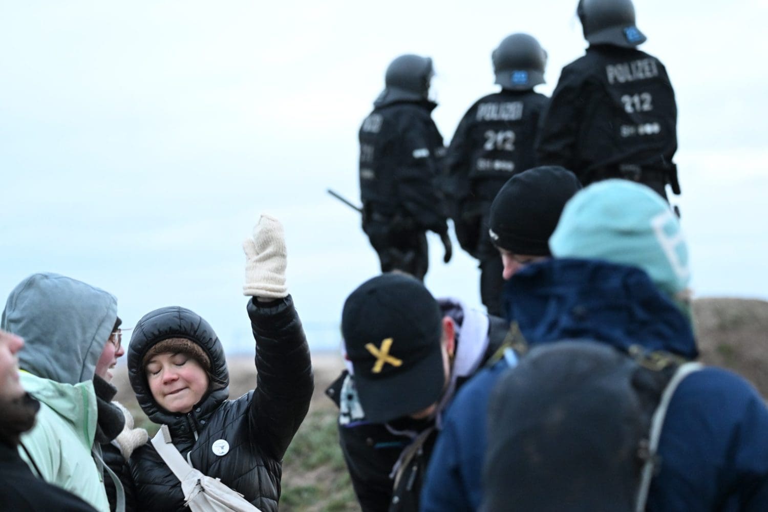 Greta Thunberg at a Lützerath with police in the background