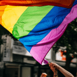 pride flag held aloft