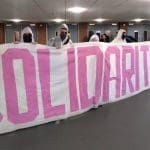 Students with a banner that says solidarity - they've been occupying universities in support of the UCU strike