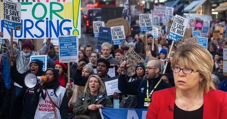 An NHS rally with Maria Caulfield looking at it - representing the nurses' strike
