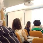 A group of people in a university lecture representing neurodiverse and autistic people who universities are failing