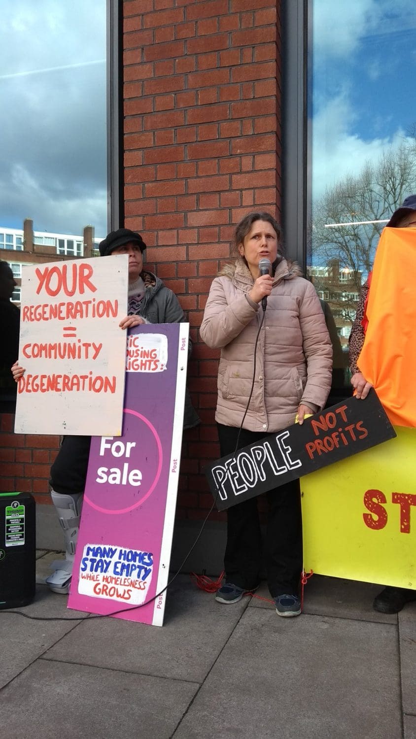 A woman speaking at a housing protest