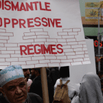 United Against Islamophobia protest - sign reading "dismantle oppressive regimes"