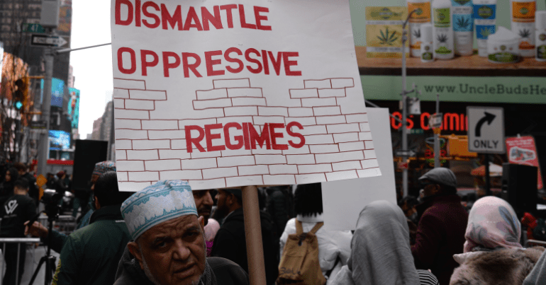 United Against Islamophobia protest - sign reading "dismantle oppressive regimes"