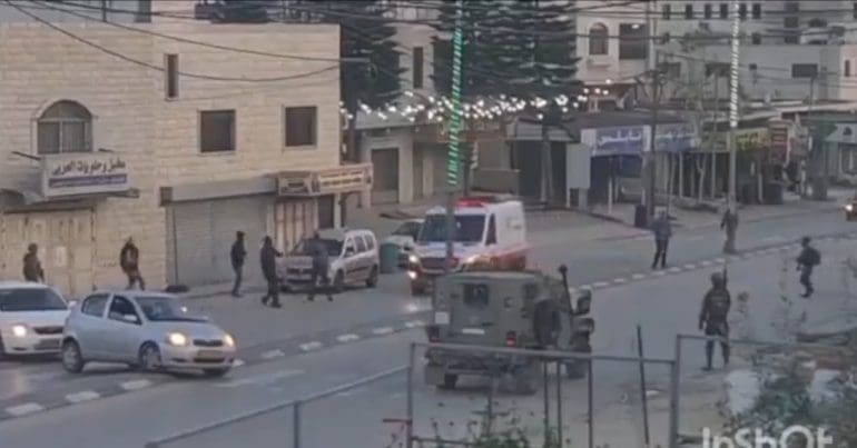 Israeli settlers attack an ambulance in Huwara, as the army protects them