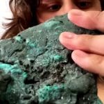 Geologist Fernanda Avelar Santos looks at a plastic rock made up in part from pollution. She found the rocks on Trinidade island.