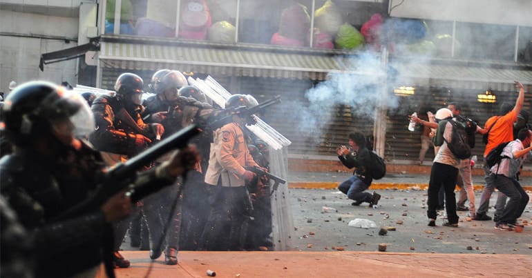 Police fire tear gas at protesters in Venezuela, as Amnesty International warns about the increasing use of rubber bullets and other 'less lethal' weaponry by security forces