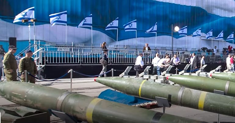 Israel's nuclear weapons depicted by a line of Israeli flags and some nuclear war heads