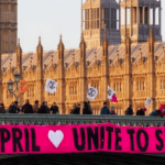 An Extinction Rebellion banner outside the houses of parliament which reads '21 April - Unite to Survive' relating to The Big One