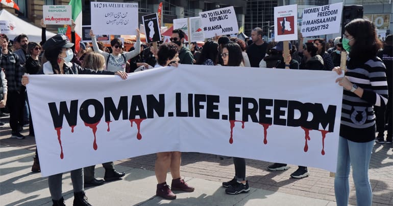 Banner that reads "Woman, Life, Freedom" from protests in Iran that has seen surging numbers of executions