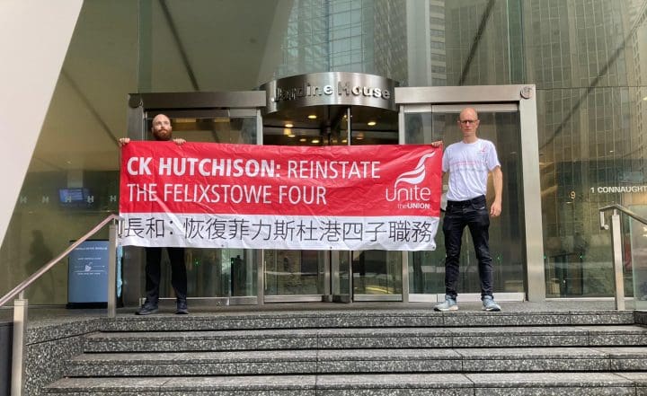 two people holding a banner which reads "CK Hutchison: Reinstate the Felixstowe Four"