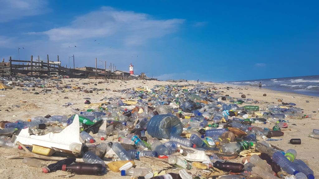 Lots of plastic bottles and other pollution on a beach in Ghana.