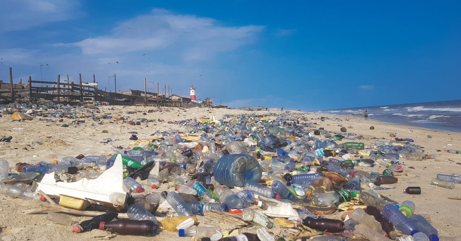 Lots of plastic bottles and other pollution on a beach in Ghana.