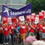 Stonewall banner at Pride in reference to the EHRC letter and GANHRI