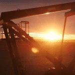 A 'nodding donkey' fracking installation in Vaca Muerta, Argentina, activists challenge fossil fuel polluters