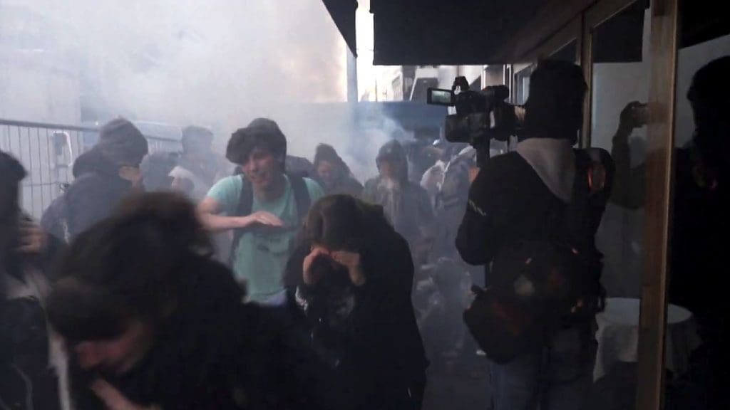 Police teargas a climate protest outside TotalEnergies AGM