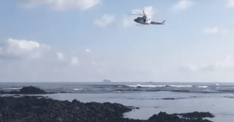 a helicopter searches for survivors after migrants die near the Canary Islands