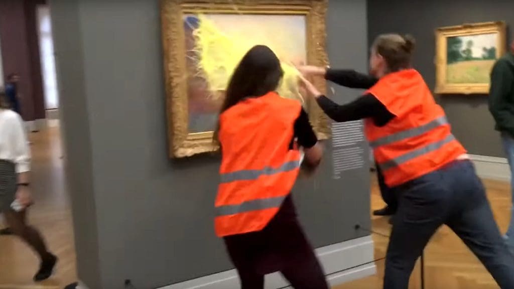 Members of Letzte Generation splash paint on a gallery painting in protest at lack of climate action by Germany's government