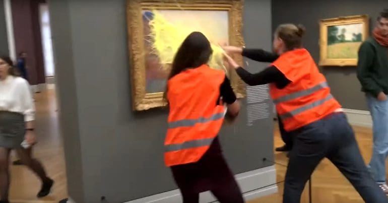 Members of Letzte Generation splash paint on a gallery painting in protest at lack of climate action by Germany's government