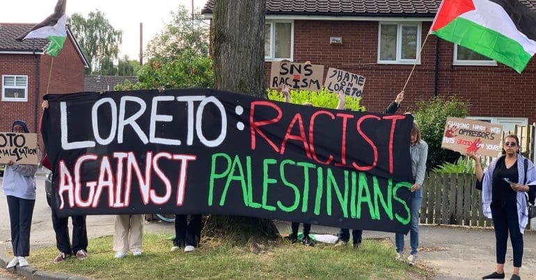 Youth Front for Palestine hold a banner during a demonstration against Loreto High School's hosting of Solutions Not Sides