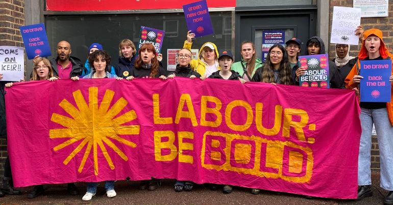 Green New Deal Rising protesters holding a banner which reads 'Labour be bold' on climate
