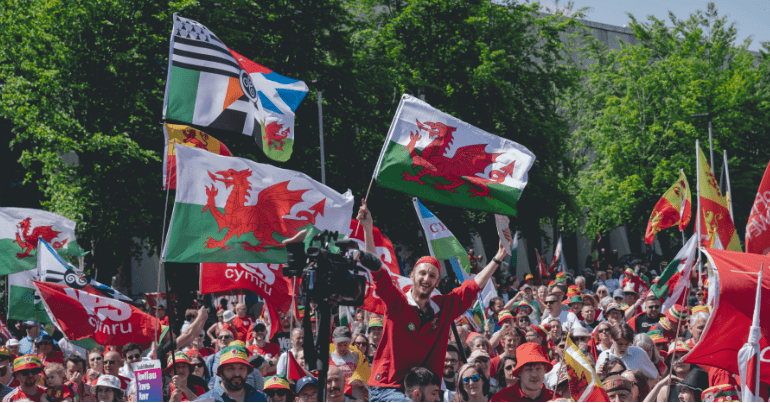 Welsh independence marchers waving Welsh flags Wales Cymru AUOBCymru