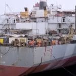 Workers on the SAFER oil tanker near Yemen transfer oil to nearby vessel.