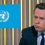 Tory minister Tom Pursglove looking at the UN logo UNCRPD disabled people