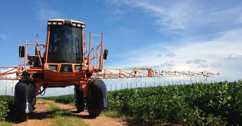 A tractor spraying some pesticides