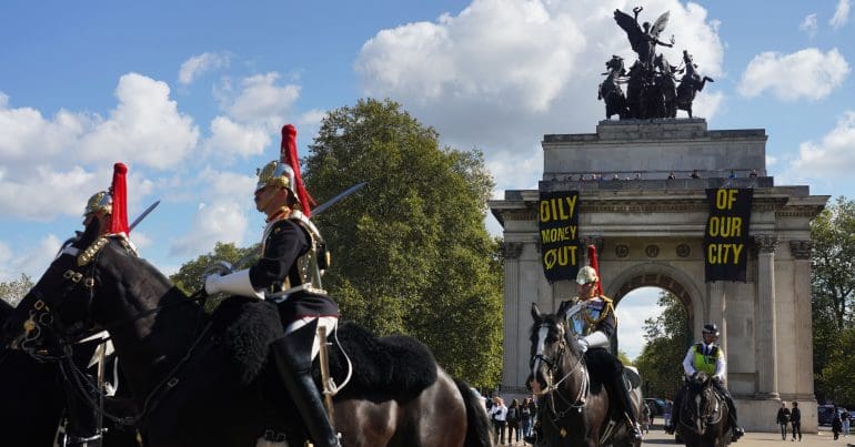 Anti fossil fuel activists protest the Energy Intelligence Forum at the Wellington Arch