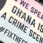 Placard from Ghana protests that says "As we speak... Ghana is a crime scene"