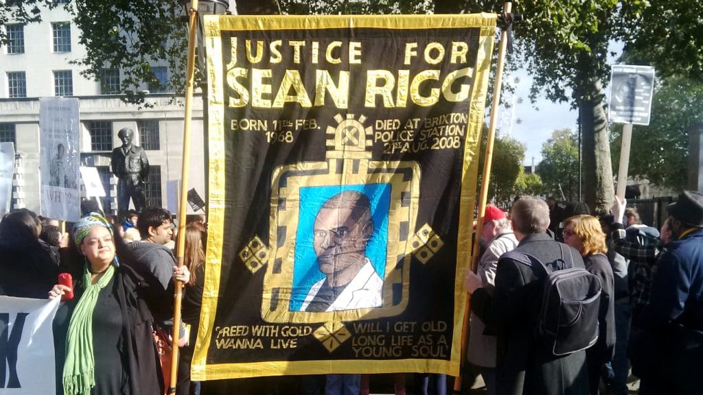 Banner at UFFC rally saying Justice for Sean Rigg