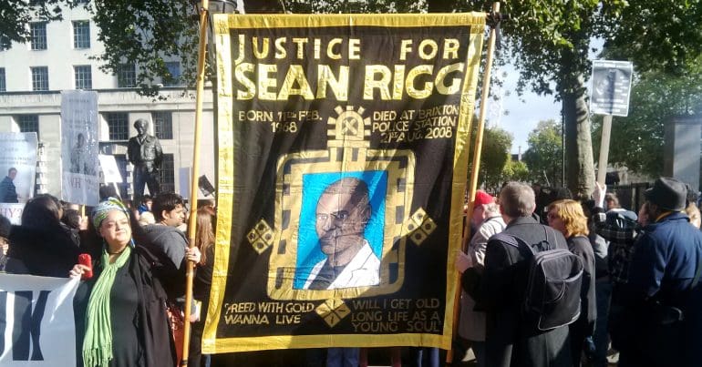 Banner at UFFC rally saying Justice for Sean Rigg