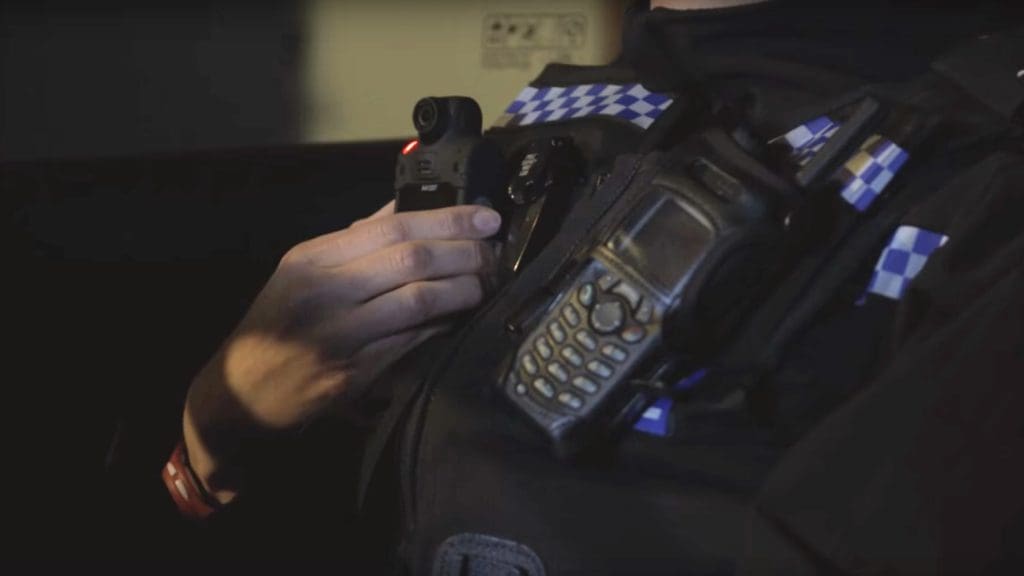 Police officer switches on a body-worn camera