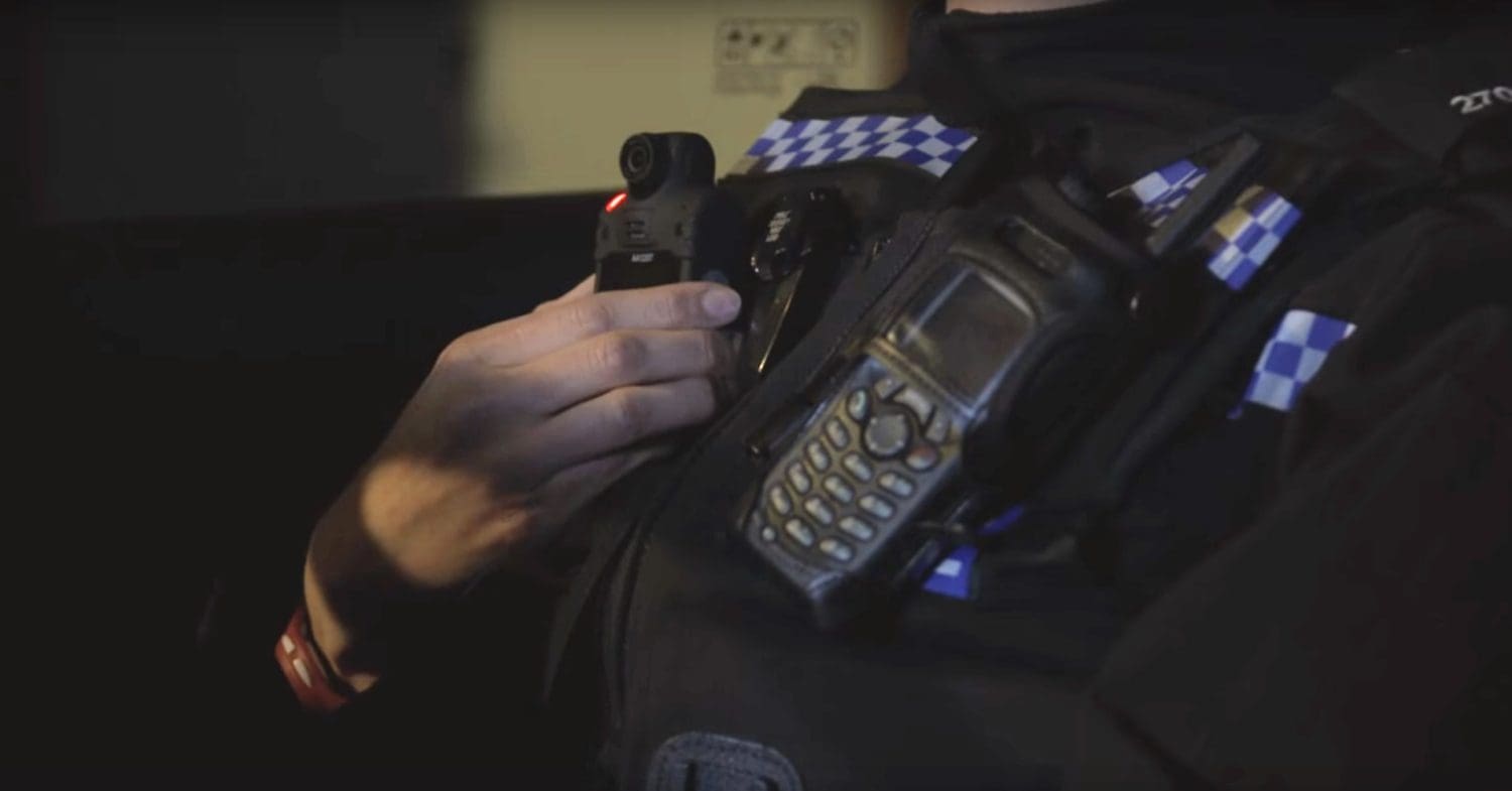 Police officer switches on a body-worn camera