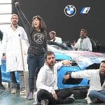 Scientists Rebellion activists glue their hands to a BMW vehicle in protest over the companies lobbying against climate action.