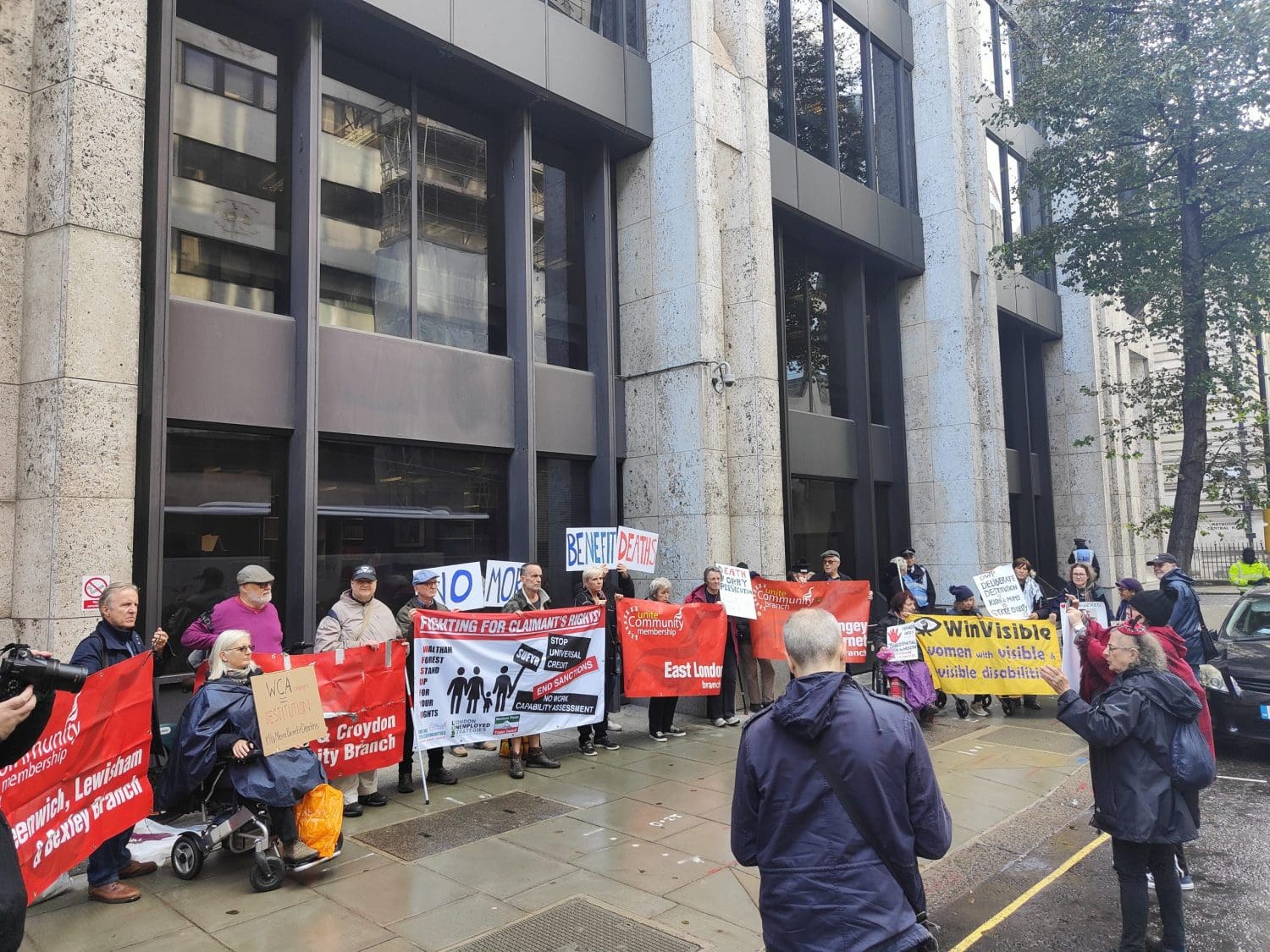 Members of DPAC protesting outside the DWP's head office