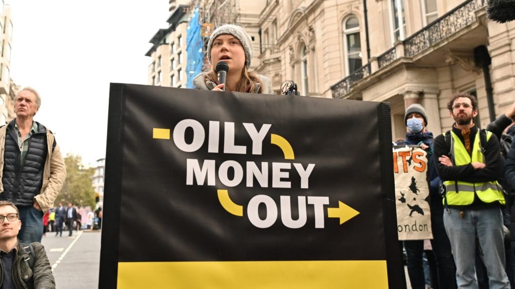 Climate activists including Fossil Free London disrupt the Energy Intelligence Forum, London, UK. Greta Thunberg holds a banner that reads: Oily money out.