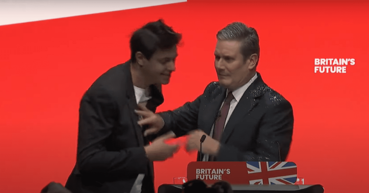 Electoral reform protester showers Keir Starmer in glitter at the start of his keynote conference speech.