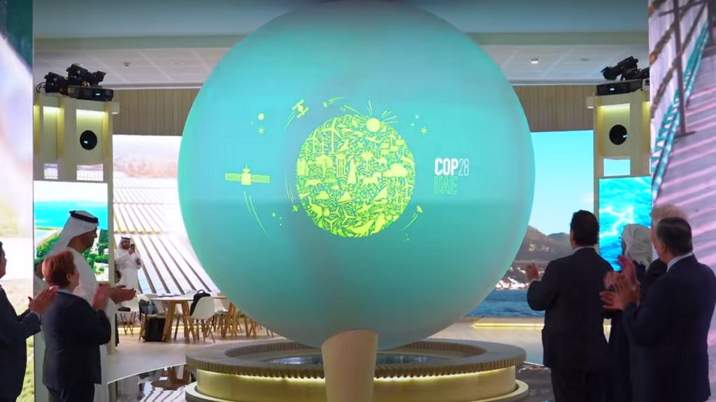 COP28 logo revealed on an interactive screen.