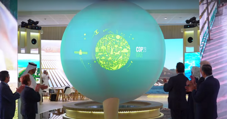 COP28 logo revealed on an interactive screen.