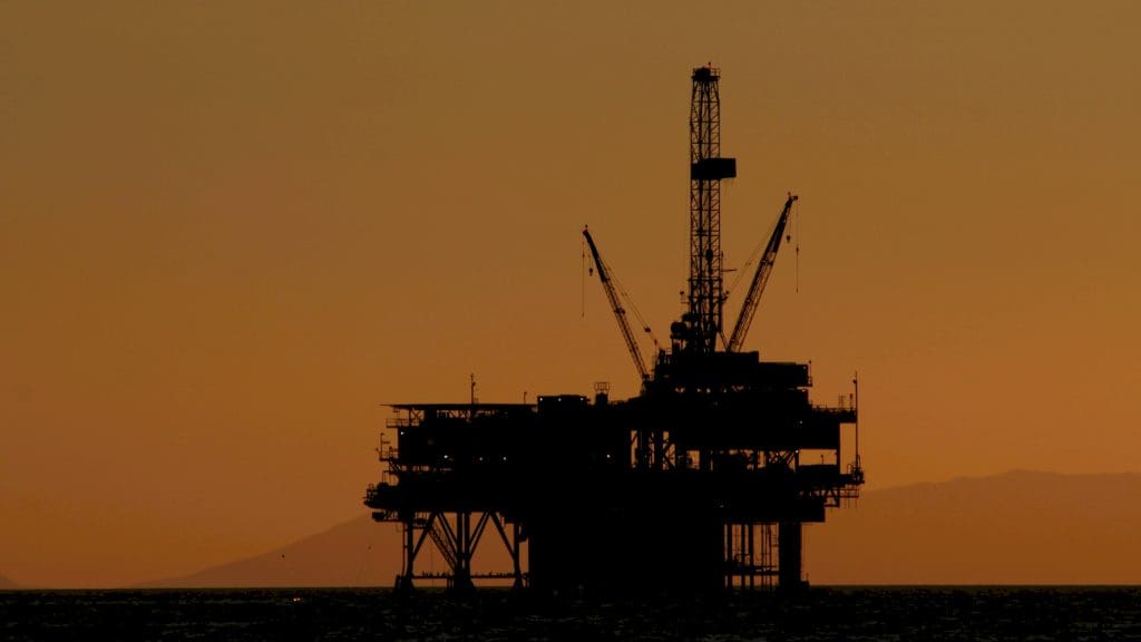 Silhouette of an oil rig at sunset