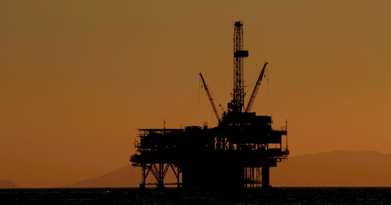 Silhouette of an oil rig at sunset