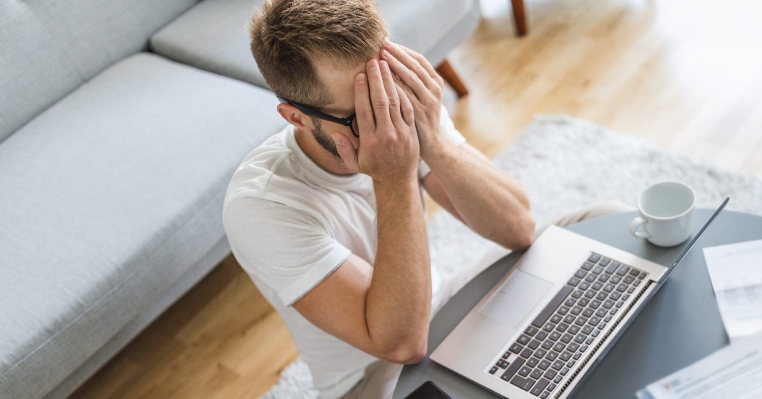 Man holding head in hands holiday pay