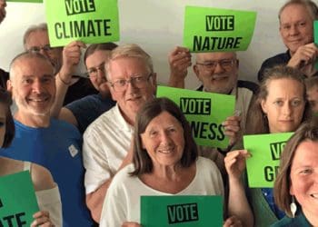 Green Party members holding signs
